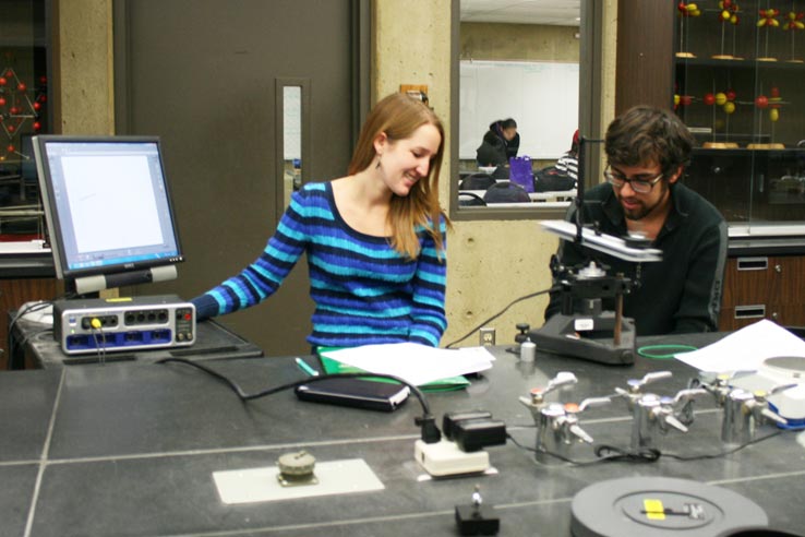 Two students doing a physics experiment.